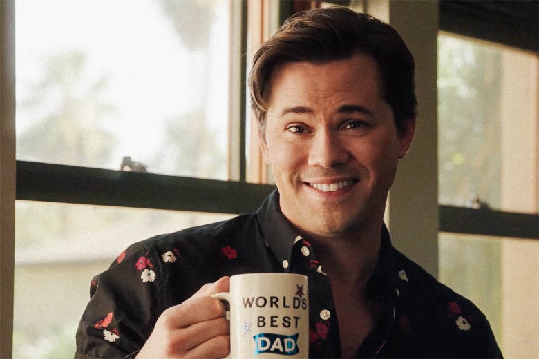 Andrew Rannells’ character holds up a "World’s best dad" coffee mug.